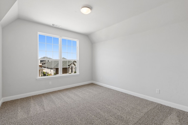 bonus room featuring baseboards, visible vents, vaulted ceiling, and carpet flooring