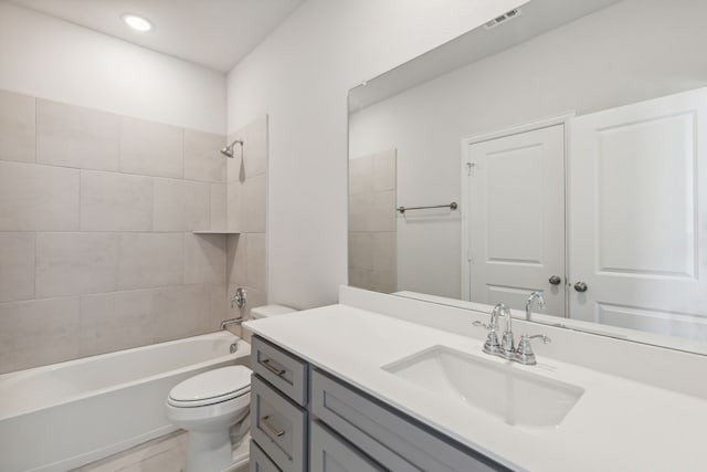 full bathroom featuring visible vents, shower / washtub combination, vanity, and toilet