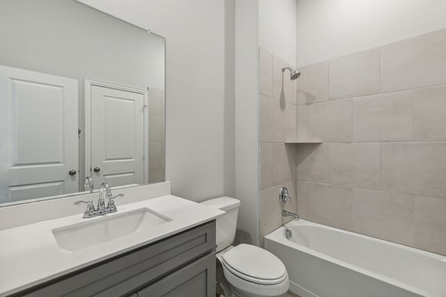 bathroom featuring toilet, tub / shower combination, and vanity