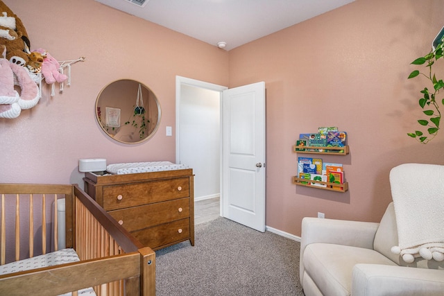 carpeted bedroom featuring a nursery area, visible vents, and baseboards