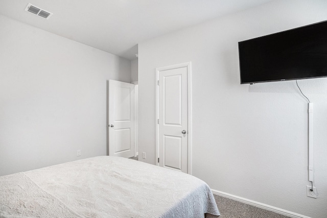 carpeted bedroom with baseboards and visible vents