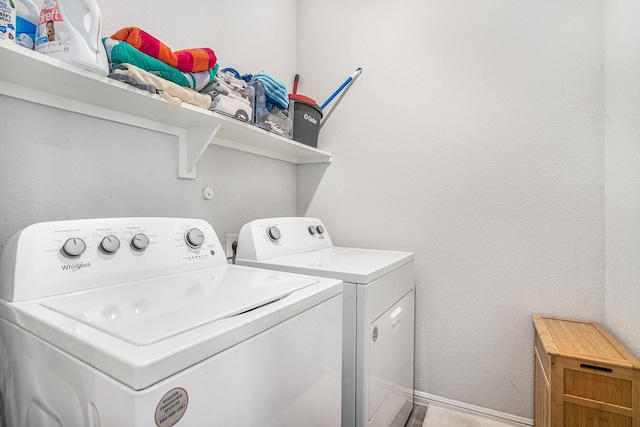 laundry room with washing machine and dryer, laundry area, and baseboards