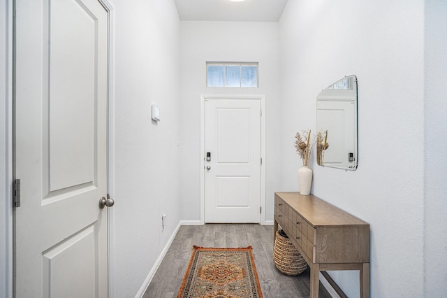 doorway to outside featuring light wood-style flooring and baseboards