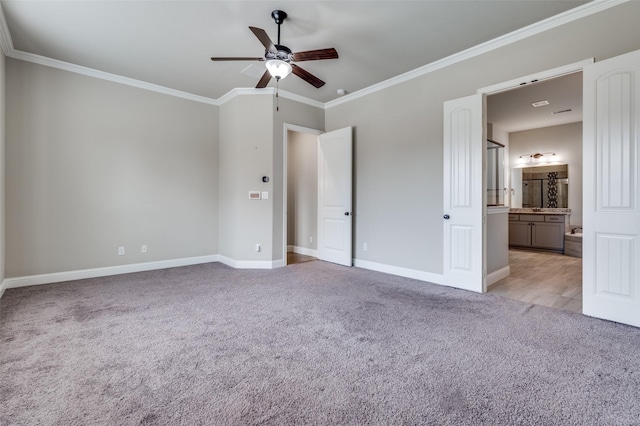 unfurnished bedroom with ceiling fan, connected bathroom, light carpet, baseboards, and ornamental molding