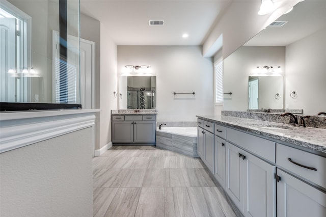 full bath featuring a stall shower, visible vents, a sink, and a bath