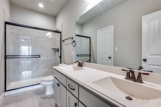 full bath with toilet, a shower stall, a sink, and tile patterned floors