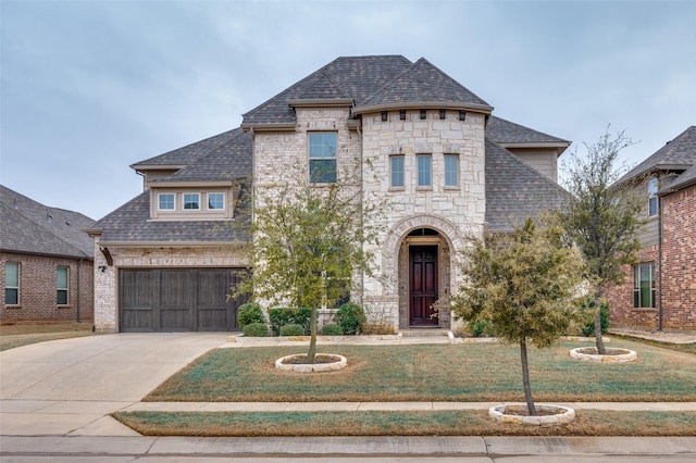 french country inspired facade with driveway, brick siding, and roof with shingles