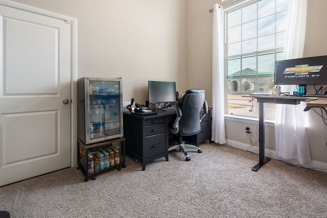 carpeted home office with baseboards