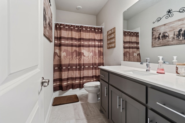 bathroom featuring toilet and vanity