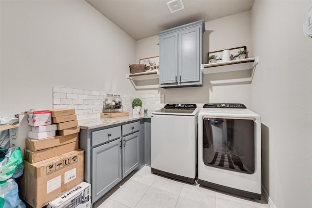 1016 Northern Oaks Ct, Springtown, TX 76082 - laundry area featuring separate washer and dryer, cabinet space, and light tile patterned floors