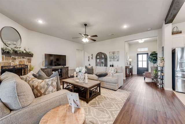 1016 Northern Oaks Ct, Springtown, TX 76082 - living room featuring wood finished floors, a ceiling fan, a stone fireplace, recessed lighting, and baseboards