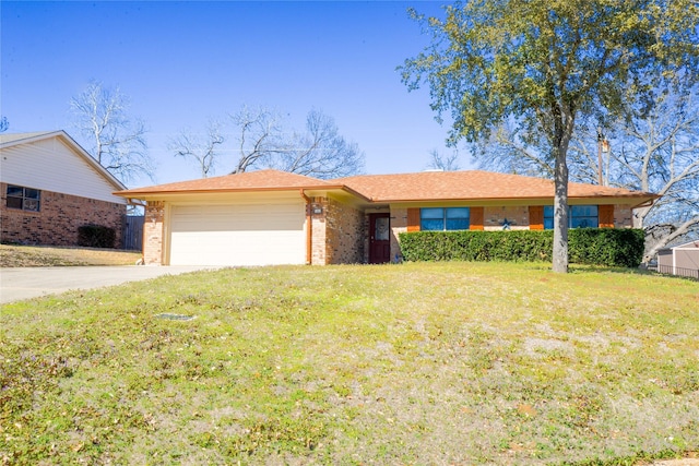 ranch-style home with a front lawn, concrete driveway, brick siding, and an attached garage