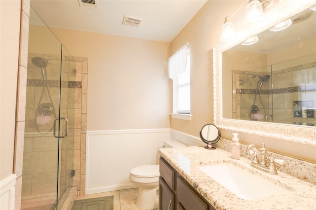 bathroom featuring wainscoting, a shower stall, visible vents, and tile patterned floors