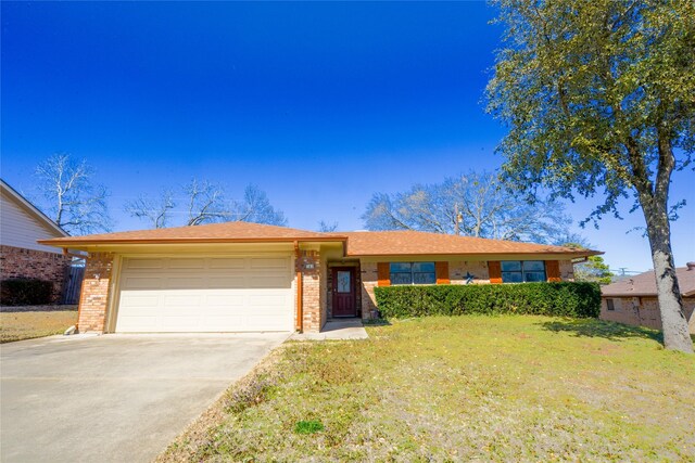 ranch-style house featuring a garage, brick siding, concrete driveway, and a front yard