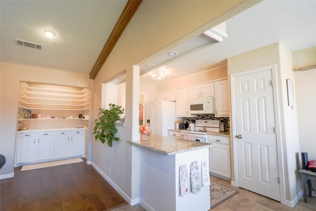 kitchen with visible vents, white appliances, white cabinetry, and light stone countertops