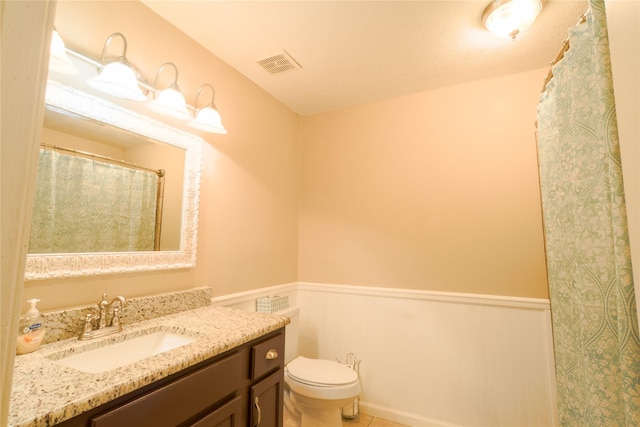 bathroom with tile patterned flooring, visible vents, vanity, and toilet