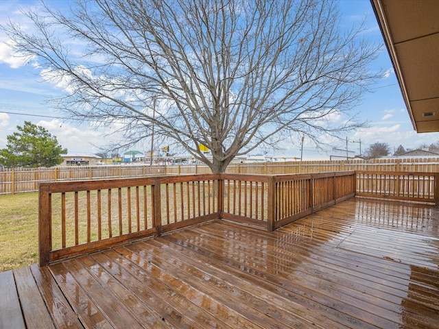 wooden deck with a fenced backyard and a yard