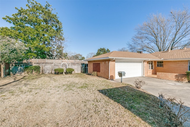 view of side of property featuring an attached garage, brick siding, fence, driveway, and a lawn