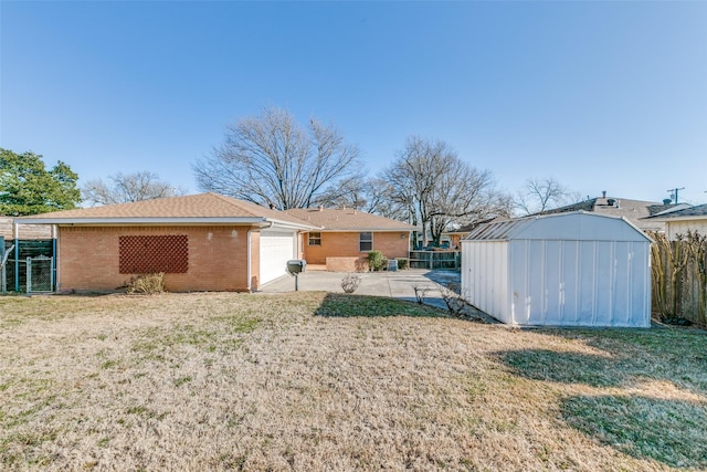 rear view of house featuring a storage shed, fence, a lawn, and brick siding