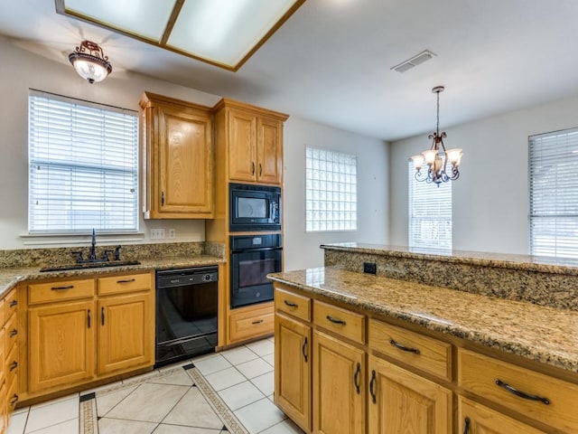 kitchen featuring a healthy amount of sunlight, visible vents, a sink, and black appliances