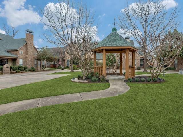 view of property's community featuring a lawn and a gazebo