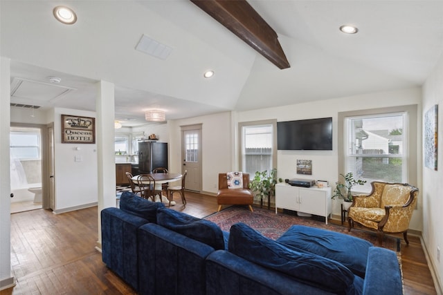 living room featuring a wealth of natural light, vaulted ceiling with beams, and hardwood / wood-style floors