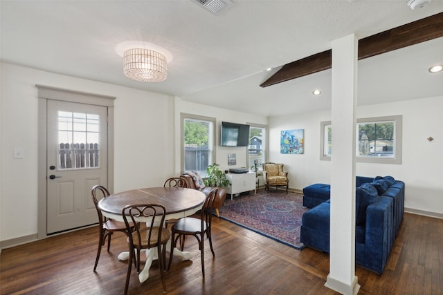 dining room featuring vaulted ceiling with beams, baseboards, visible vents, and wood finished floors