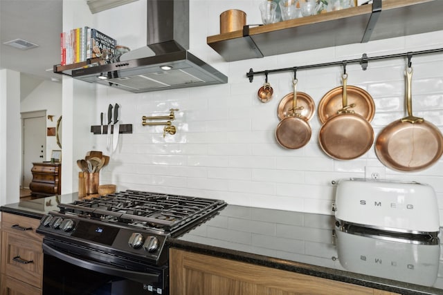 kitchen featuring tasteful backsplash, visible vents, brown cabinetry, gas stove, and extractor fan