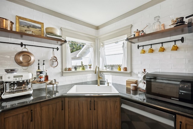 kitchen featuring open shelves, backsplash, dark countertops, and a sink