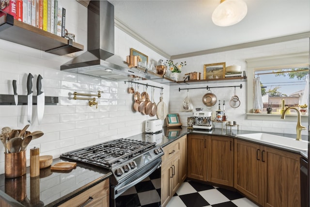 kitchen with wall chimney exhaust hood, stainless steel gas range, light floors, open shelves, and a sink