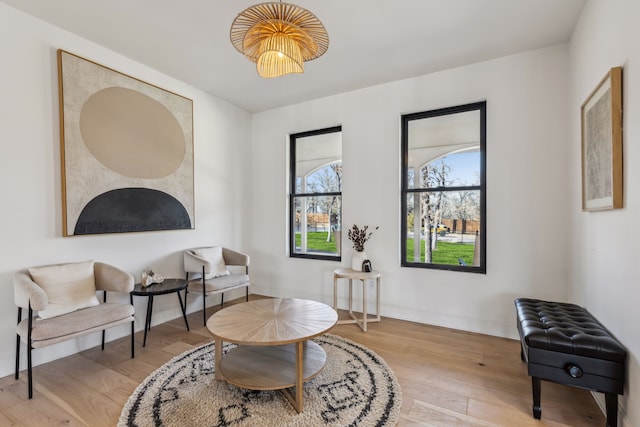 sitting room featuring baseboards and wood finished floors