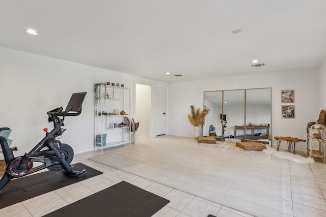 exercise room featuring light tile patterned floors, baseboards, visible vents, and recessed lighting