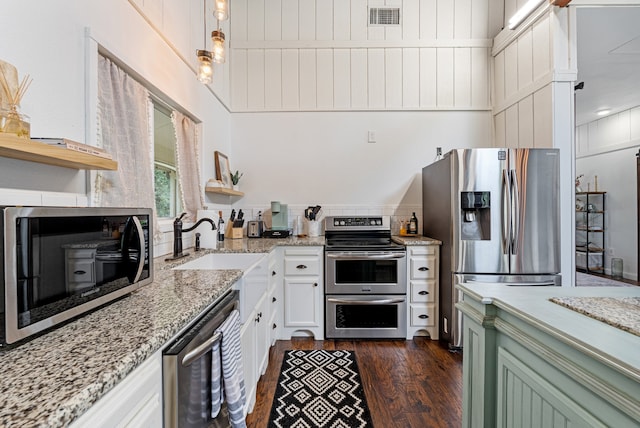 kitchen featuring light stone counters, stainless steel appliances, dark wood-style flooring, visible vents, and open shelves