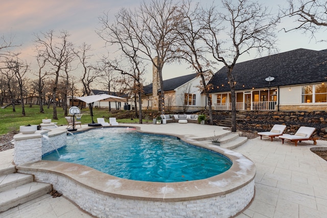 outdoor pool with an outdoor living space and a patio