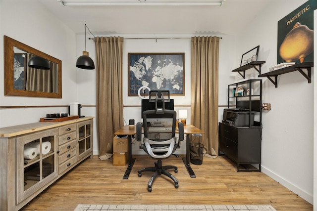 office with light wood-style floors and baseboards