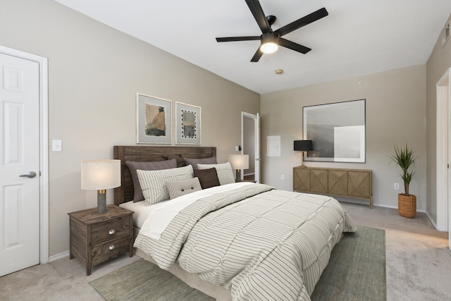 bedroom with light carpet, ceiling fan, and baseboards