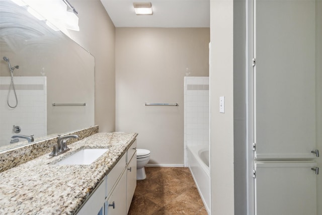 bathroom featuring baseboards, vanity, toilet, and shower / bathtub combination