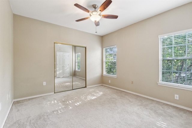 unfurnished bedroom with carpet, baseboards, and a closet