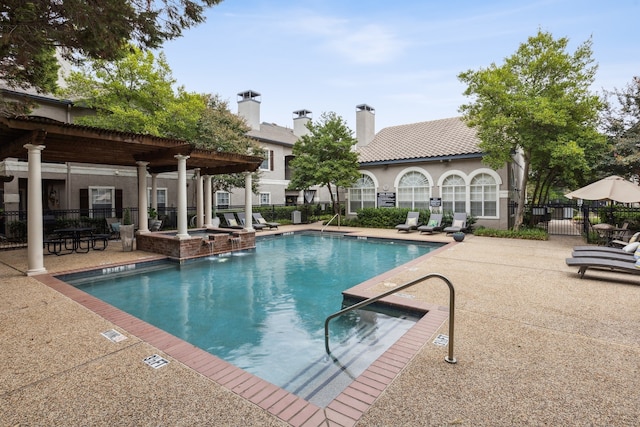 pool featuring a patio, fence, and a pergola