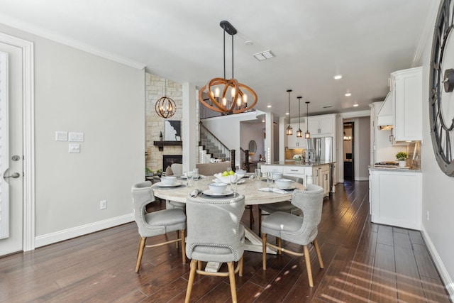 dining area featuring a chandelier, crown molding, baseboards, and dark wood-style flooring