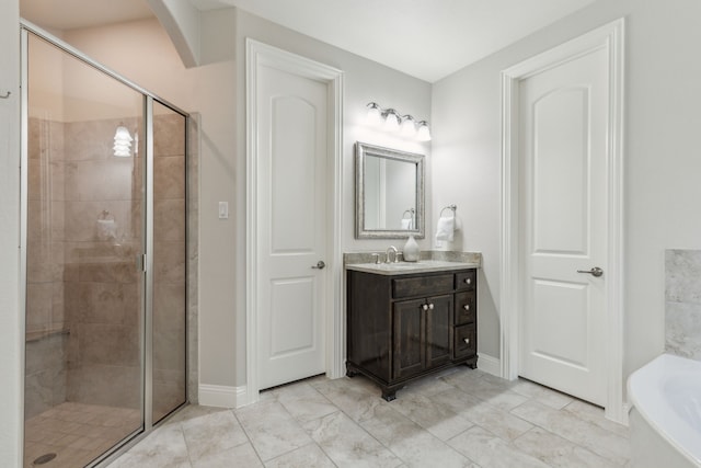 bathroom with a garden tub, a stall shower, and vanity