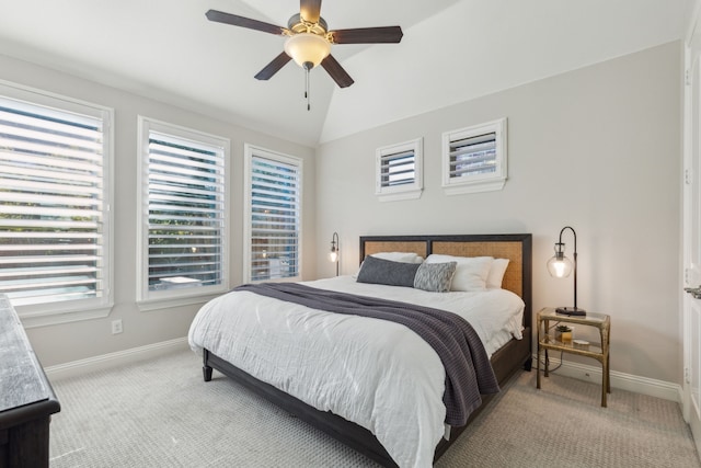 bedroom featuring light carpet, a ceiling fan, baseboards, and vaulted ceiling