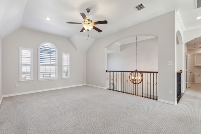 spare room featuring visible vents, baseboards, carpet, vaulted ceiling, and ceiling fan with notable chandelier