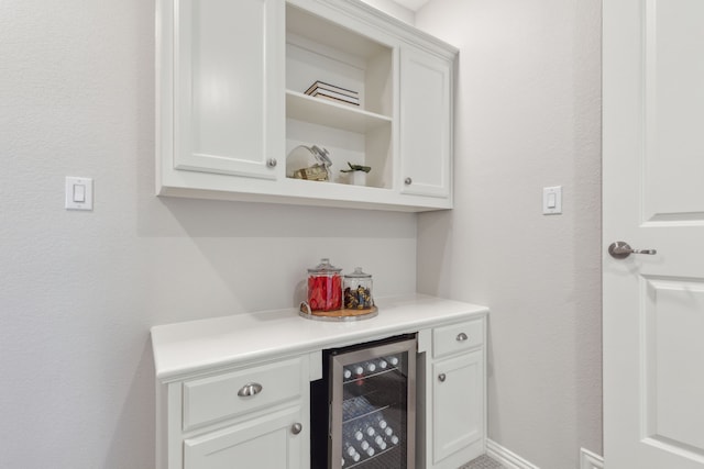 bar featuring beverage cooler and baseboards