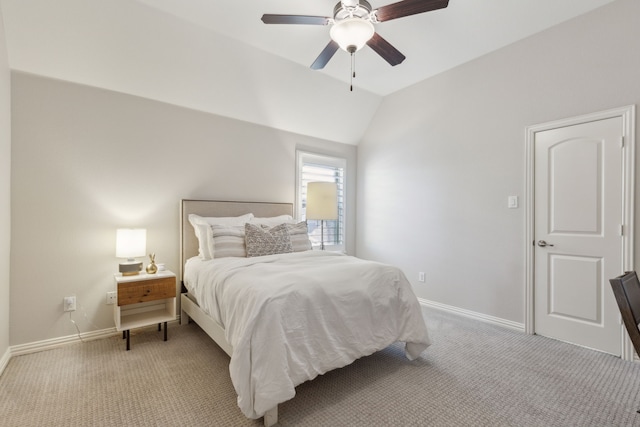 bedroom featuring baseboards, light carpet, ceiling fan, and vaulted ceiling