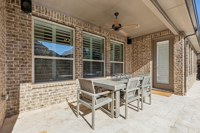 view of patio featuring outdoor dining area and a ceiling fan