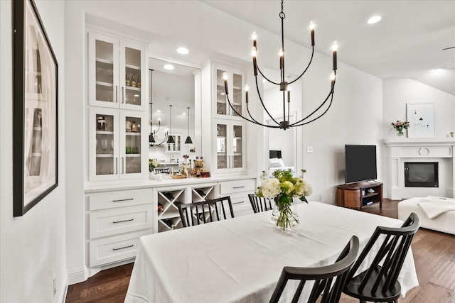 dining area with a chandelier, recessed lighting, and dark wood finished floors