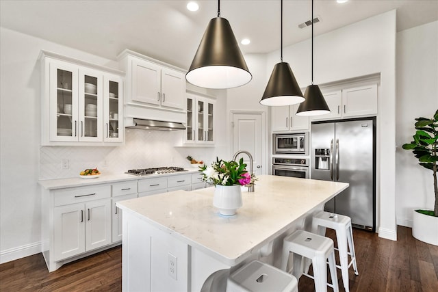 kitchen featuring dark wood-style floors, white cabinets, and appliances with stainless steel finishes