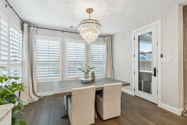 dining space featuring dark wood-style floors, a chandelier, and baseboards