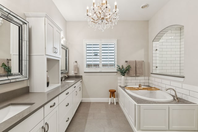 full bath featuring double vanity, a sink, baseboards, and a bath